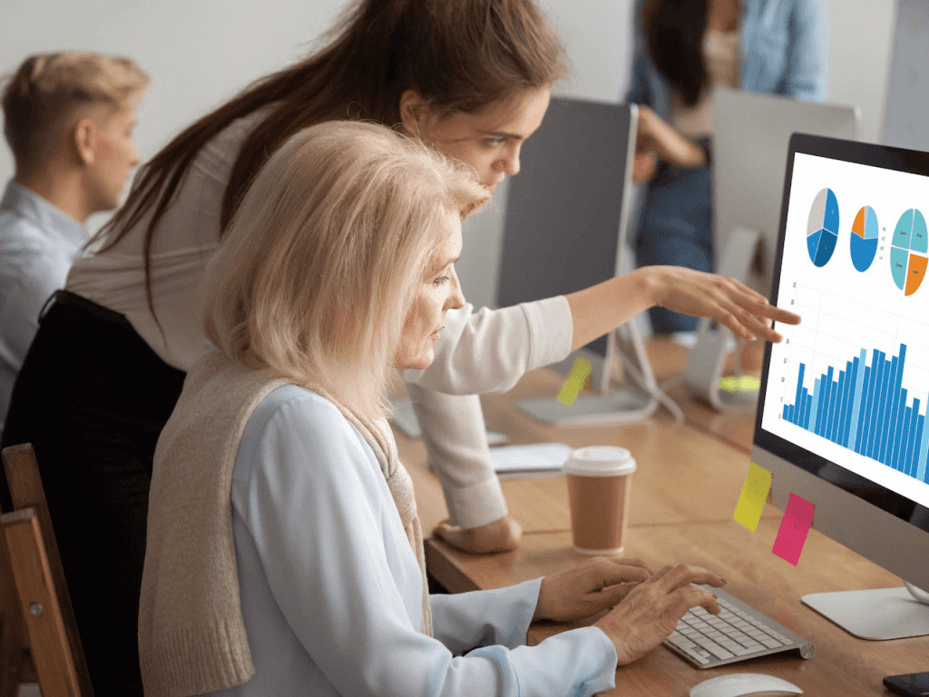 Image of two employees working on desk