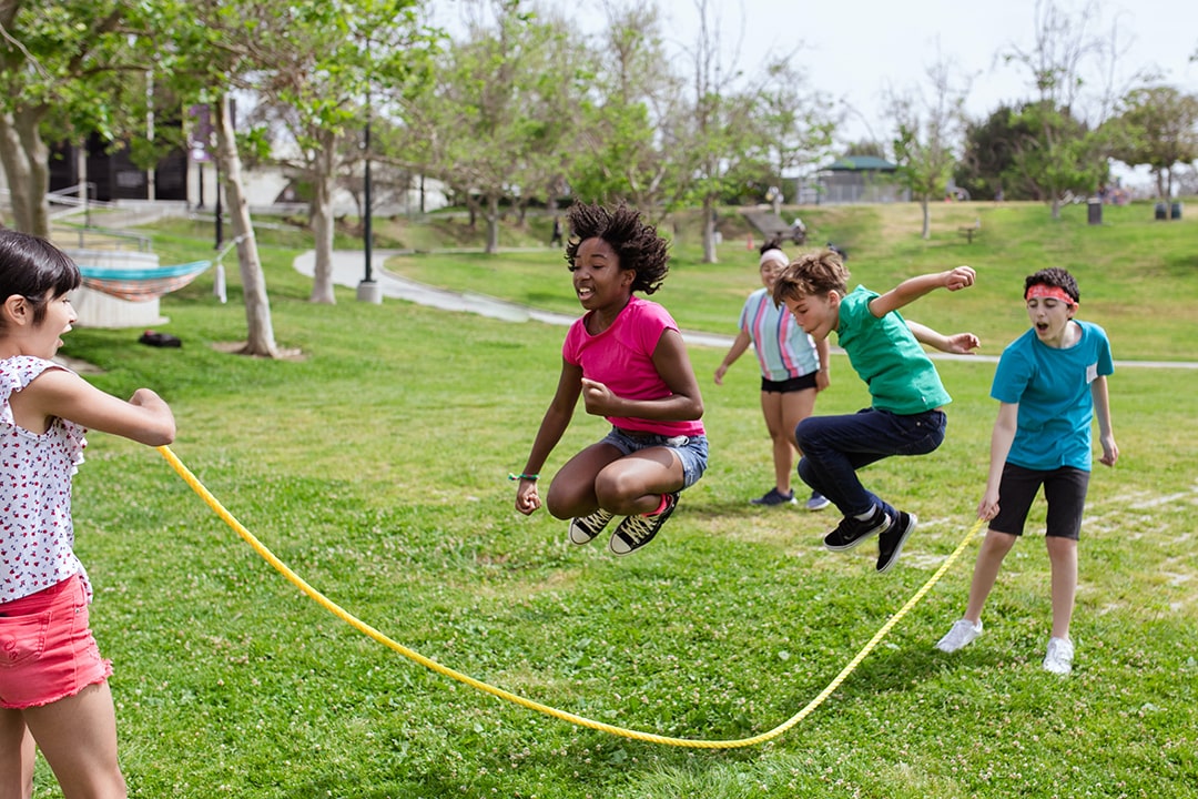 Students playing jump rope while practicing summer safety Students playing jump rope while practicing summer safety